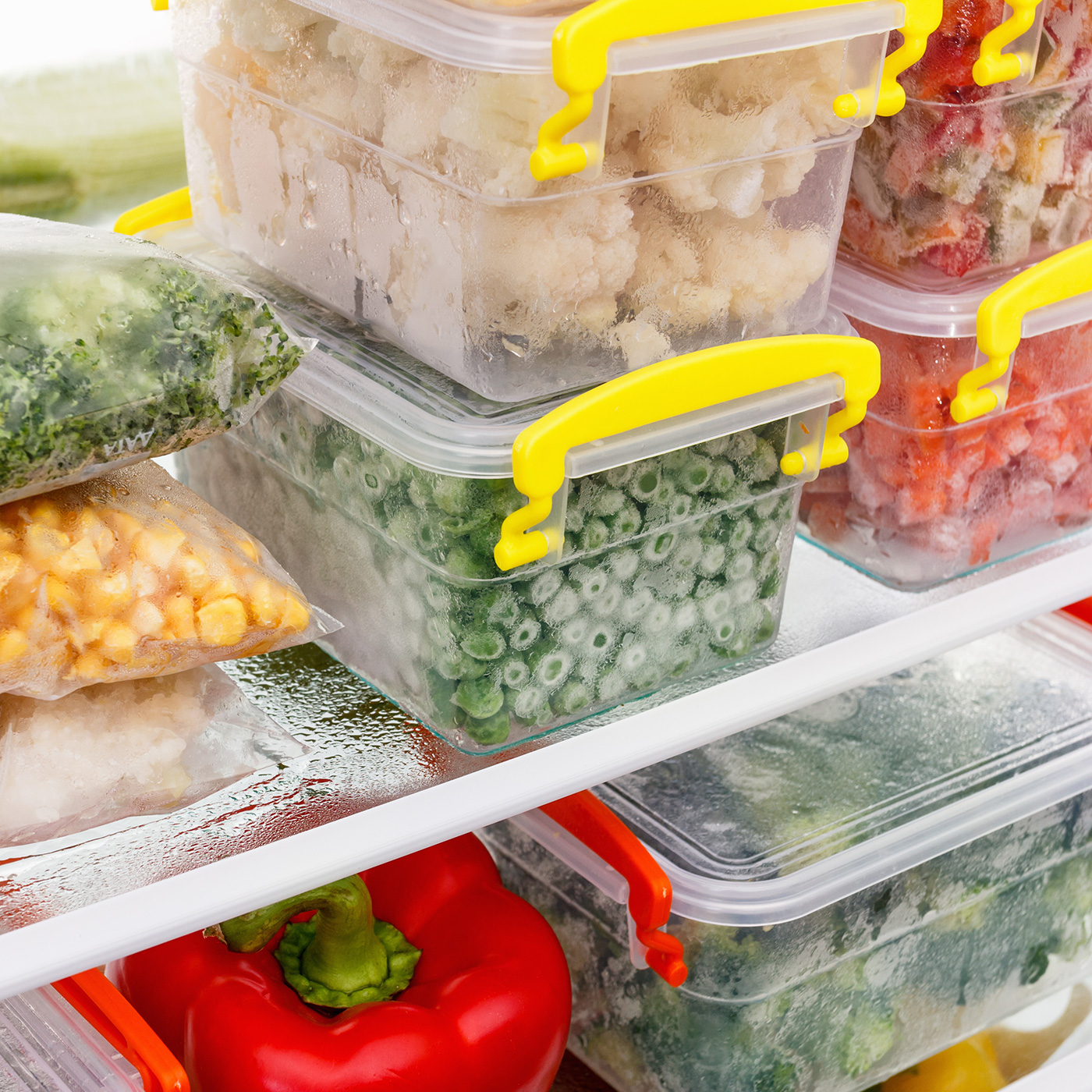 Organized containers of vegetables in a refrigerator