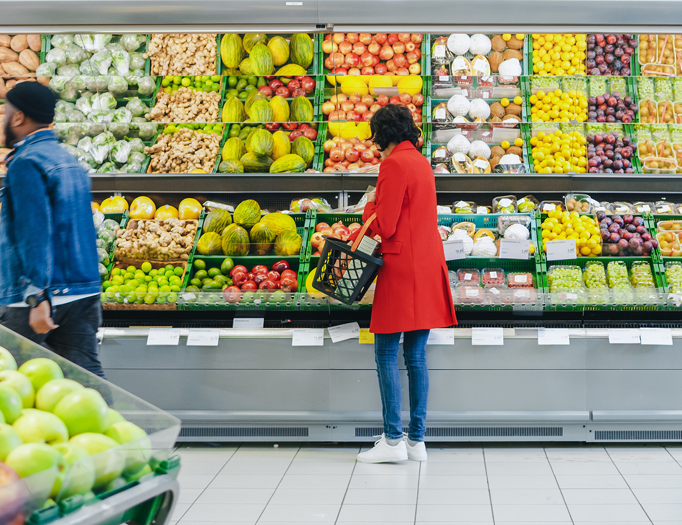 Shoppers at a grocery store in the produce section