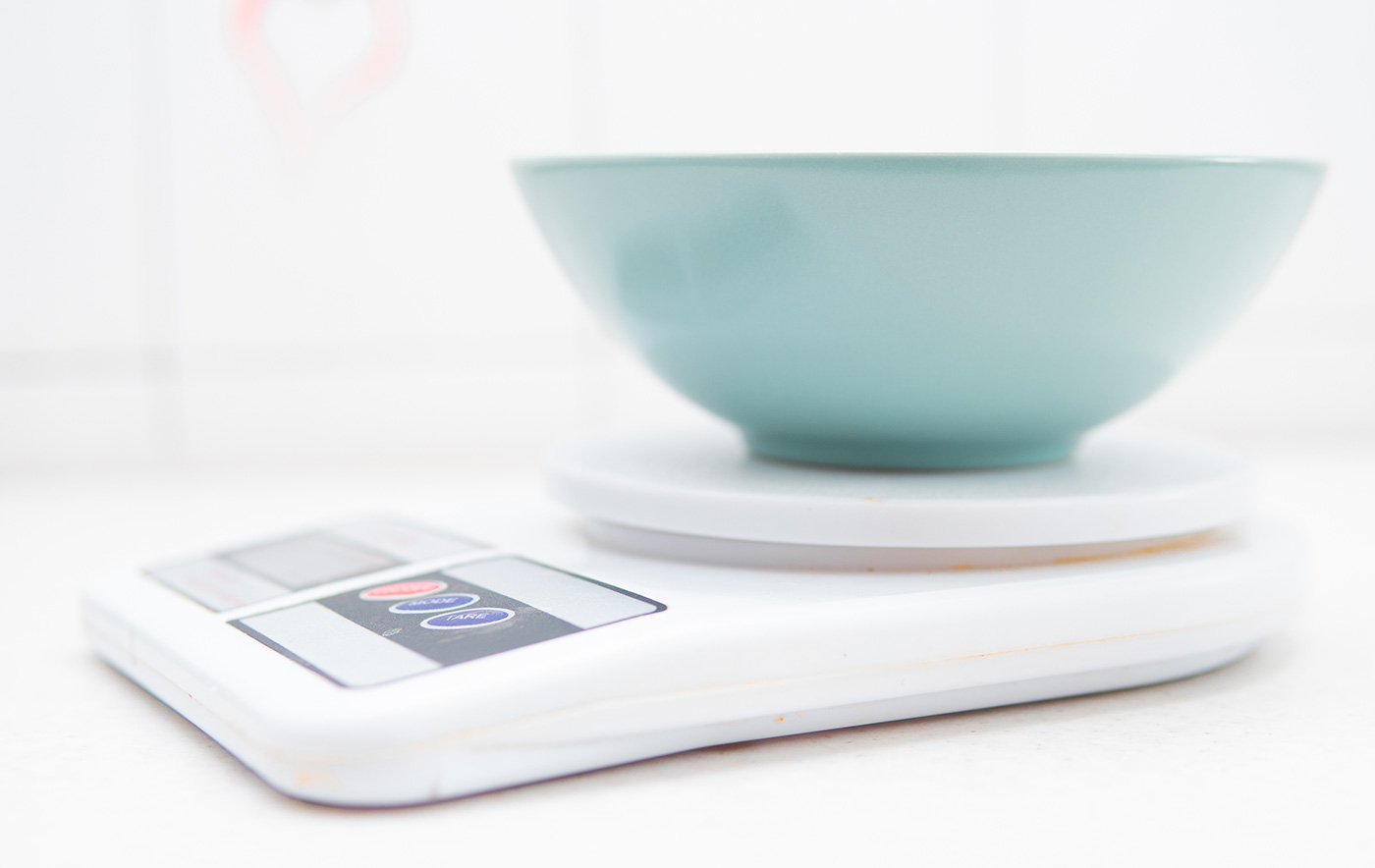 A bowl on a kitchen scale for weighing food