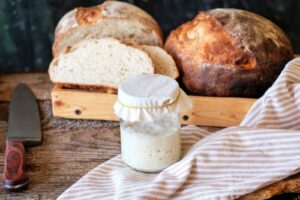 Sourdough starter and loaves of sourdough bread