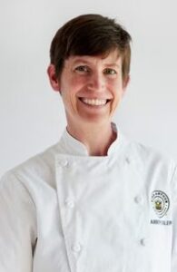 Portrait of Amber Eisler in chef coat